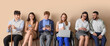 © Pixel-Shot - Job applicants with woman in wheelchair waiting for interview near beige wall