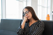 © Daniel - Young woman with closed eyes resting her head on her hand. Showing fatigue and boredom while waiting in an airport terminal. Possibly experiencing a travel delay or long layover