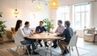 © MariaMahmud - Diverse business team collaborating around a table during a strategy meeting