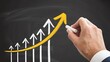 © MdSahab - Businessman hand drawing rising yellow arrow on blackboard with chalk showing financial business growth success