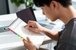 © li - Young man checking calendar at desk
