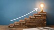 © Riski Digital Studio - Steps to innovation and growth with wooden blocks and glowing bulb.