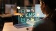 © Jo - CMS Content Management, Digital Asset Workflow, and Media Marketing Optimization Concept: Glowing Teal Holographic Interface with Video, Folder, and Upload Icons Over Businesswoman Desk Setup.
