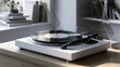 © visoot - Modern turntable with vinyl record on wooden table in bright minimalist room, sunlight streaming through window, peaceful atmosphere
