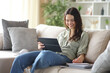 © Antonioguillem - Happy student taking notes e-learning with a tablet at home