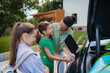 © Halfpoint - Daughter helping mom to charging electric car while family prepares for summer trip.