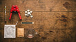 © Enes - Home beer brewing kit components flat lay on dark oak surface overhead copy space, home brewing kit concept, craft beer making supplies, beer brewing tools overhead, DIY beer kit flat lay