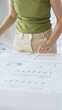 © rogerphoto - Professional female executive analyzing financial data, pointing toward charts displaying business performance metrics and comparative analysis. Business people concept