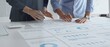 © rogerphoto - Professional business team analyzing financial reports, sharing insights and planning strategic decisions in modern workplace setting