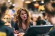 © Olga Ко - Frustrated female customer complaining to staff and demanding a refund at grocery store checkout.