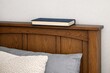 © Fotograf - A comfortable bed with a book placed on top, perfect for a quiet evening or a relaxing weekend