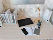 © Анна Маркина - Desk with student supplies and laptop for remote learning. Workspace setup with notebook, stationery, phone, and lamp. Concept of organized study area in home interior for education.