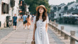 © AS_SleepingPanda - Woman in white dress walking down a city street with a confident stride