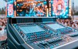 © vectorizer88 - Professional audio mixing console at outdoor concert with vibrant lights