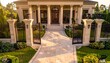 © ExploreAI - Luxurious mansion with grand entrance featuring tall columns supporting portico, large double glass-paneled doors, symmetrical architectural design, light-colored stone tile pathway flanked by manicur