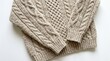 © Being Guru - Closeup of a beige cable knit sweater isolated on white background