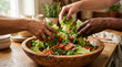 © Saad - Hands gently tossing a fresh salad with lettuce, tomatoes and carrots in a large wooden bowl on a sunny kitchen counter, suited for healthy meal and food lifestyle projects.