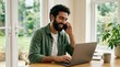 © Gennyson Marinho - Young professional engaged in remote work from home focused on laptop amidst a bright