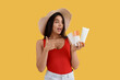 © Pixel-Shot - Beautiful young woman pointing at bottles of sunscreen cream on yellow background