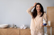 © Pixel-Shot - Pretty young woman with hair dryer in bathroom