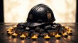 © Alice - Worn black miner helmet placed atop a pile of coal surrounded by glowing tea light candles in a dimly lit setting representing the hard work