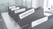 © Wankatsu - Close up of black office folders with compliance regulation audit risk and policy labels in a clean professional workspace corporate business lifestyle concept