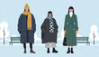 © Afjol - Three stylishly dressed young women in warm winter coats standing together in a snowy park during wintertime.