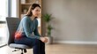 © Muhammed - Woman Sitting On Chair With Tailbone Pain