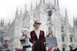 © Cavan Images - Stylish woman with shopping bags in Milan