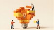 © YiuCheung - Mini figures build a lightbulb from LEGO blocks, symbolizing creativity and innovation.