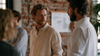 © forenna - Startup team gathered in converted warehouse reviewing equity distribution chart pinned to exposed brick wall, casual attire, founder shares discussion, early stage company