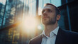 © Keopaserth - Confident business employee male portrait office building modern city sunlight suit white shirt beard professional looking up urban background business person young adult corporate worker exterior