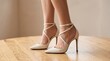 © PNG shops - Elegant woman wearing stylish cream colored high heel shoes with thin ankle straps and pointed toes captured in a soft natural light close up shot