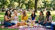 © sambath - A group of women sitting on a blanket in a park, enjoying a picnic with food and drinks.