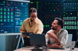 © Zamrznuti tonovi - Diverse it team collaborating on data center network monitoring and system security in a server room