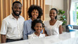 © Muhammad - Family of four, two adults and two children, smiling at camera, standing behind a counter in a bright, modern setting, representing togetherness and hospitality.
