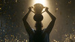 © SUYATI - Man holding up a trophy cup.