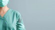 © dmmarychev - Healthcare professional in green scrubs holding dental tools with copy space