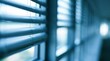 © dmmarychev - Close up of blue venetian blinds on office window with bokeh background