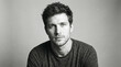 © Florence - Black and white close-up portrait of young man with short dark hair wearing dark sweater, direct serious thoughtful gaze, slightly relaxed pose, studio photograph