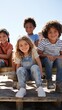 © Evon J - Group of children sitting together on outdoor wooden bench