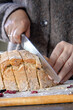 © Ina - Slicing fresh homemade bread on wooden board with flour and dried berries. Rustic baking scene, cozy kitchen moment. Concept of slow living, homemade food and authenticity.