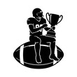 © Kazi - Football player sitting on ball holding trophy cup