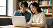 © Elizabeth_Art - Young Asian Couple Working Together on Laptop in Cozy Home Library