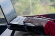 © Mihail - Close-up of hands typing on a laptop computer