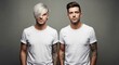 © Alane - Two men with tattoos and stylish haircuts posing in white t-shirts against a plain grey studio background