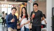 © Aifaa - Three happy people celebrating success with drinks at a small party