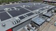 © GoAerials - Industrial building rooftops with solar panels generating renewable energy