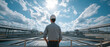 © Kingdola - Industrial Panorama: A lone engineer wearing a hard hat stands with hands in pockets, gazing out at a vast industrial complex under a dramatic sky, symbolizing progress and large-scale operations.