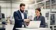 © twilight mist - Professional Engineers Discussing Project on Laptop in Modern Industrial Factory Setting